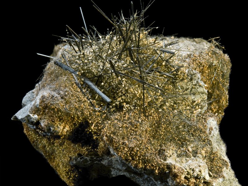Actinolite specimen showing green needle-like fibrous crystals