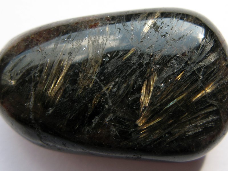 Anthophyllite specimen showing grey-brown fibrous crystals